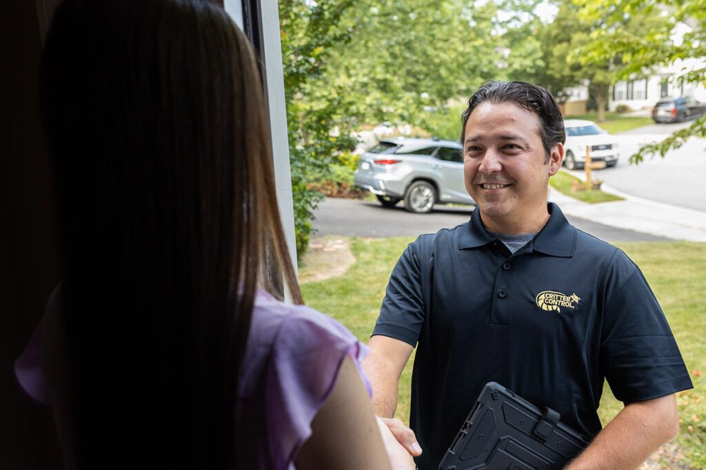 photo of a Critter Control technician at the front door of a home