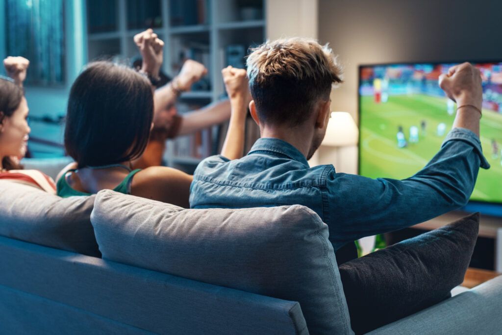 photo of a group of people watching sports on Fubo